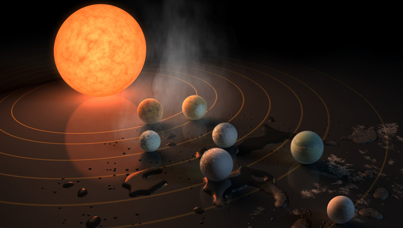 This artist’s impression displays TRAPPIST-1 and its planets reflected in a surface. The potential for water on each of the worlds is also represented by the frost, water pools, and steam surrounding the scene. The image appears on the 22 February 2017 Nature cover.